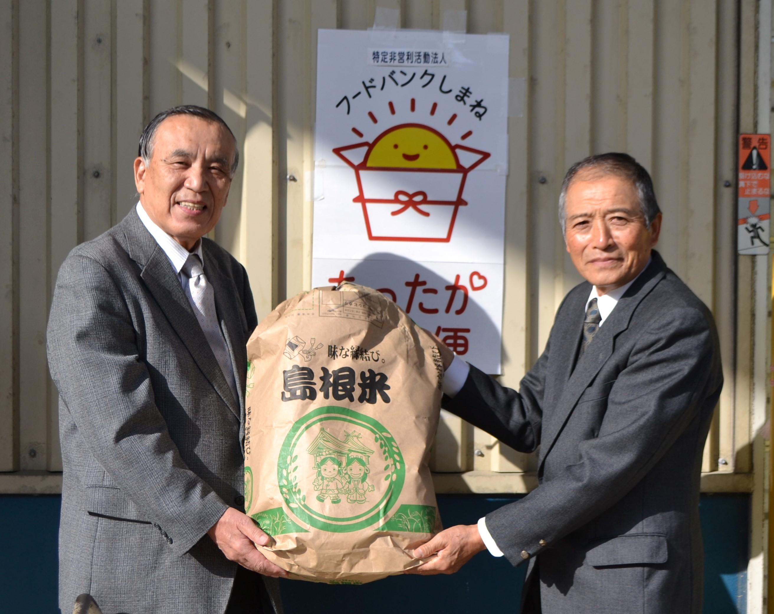 米を受け取る春日理事長(左)と前田会長(右).JPG